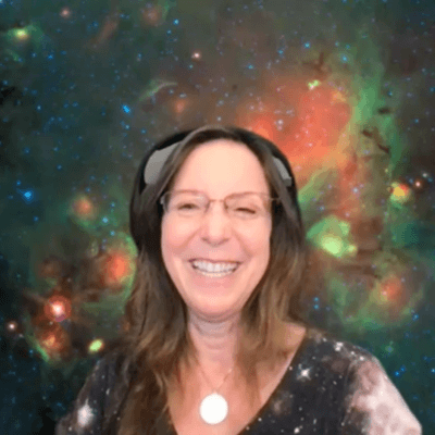 Dr. Grace Wolf-Chase smiling at the camera with an image of space in the background.